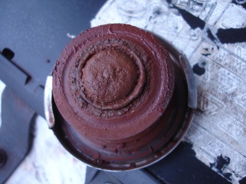 1989 Ford Taurus - A close-up shows a heavily corroded cap with visible concentric rings and a central raised area.
