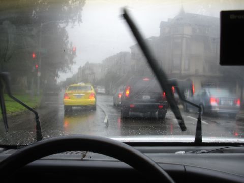 1989 Ford Taurus - Driving through traffic on a wet day, with wipers active on the windshield.