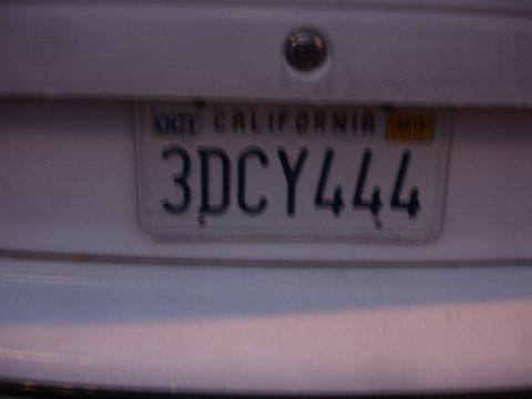 1989 Ford Taurus - A California license plate with the number 3DCY444 is visible on the back of a white vehicle.
