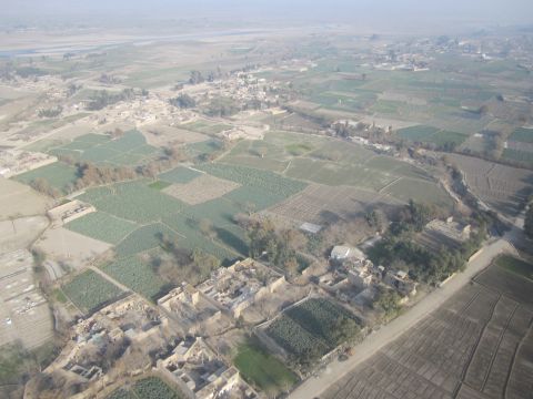 2003 Jeep Wrangler - An aerial perspective captures the patchwork of fields and structures in a rural settlement.