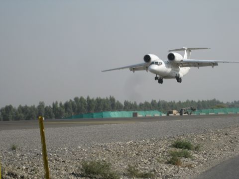 2003 Jeep Wrangler - A white twin-engine turboprop airplane is captured in mid-takeoff from an airport runway.