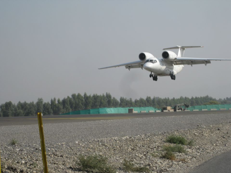 White twin-engine turboprop airplane on takeoff