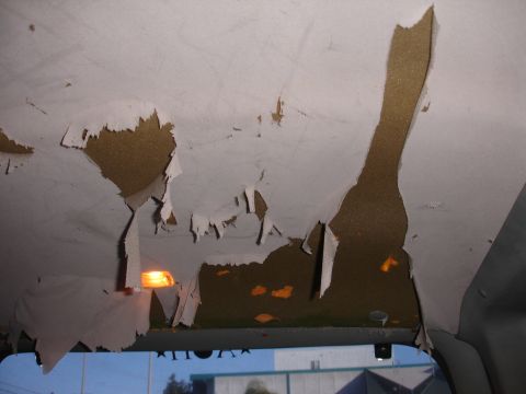 1992 Ford Explorer - The headliner in this vehicle is severely damaged, with large sections peeling away to reveal the underlying insulation.