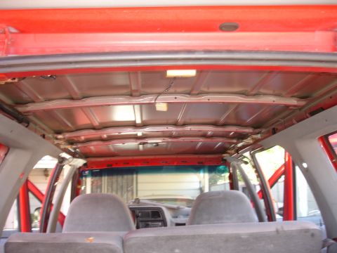 1992 Ford Explorer - The interior ceiling of a vehicle is visible, showing exposed metal supports and wiring.
