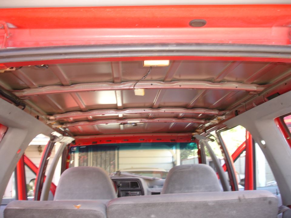 view of vehicle's exposed ceiling structure and rear seats
