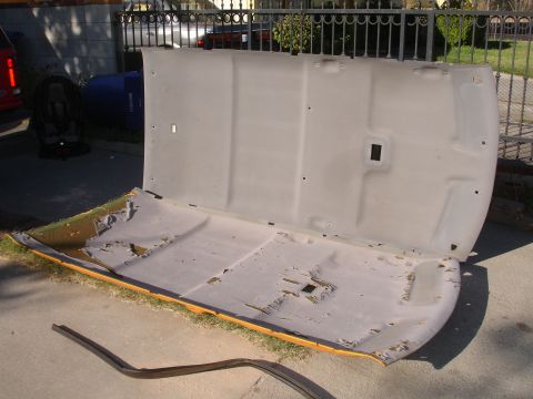 1992 Ford Explorer - A detached car headliner lies on the ground, revealing its damaged fabric and underlying structure.