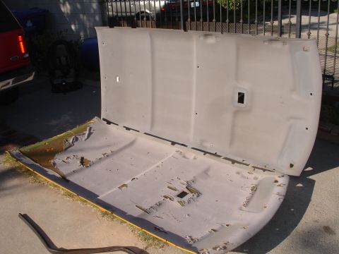 1992 Ford Explorer - Removed car headliner with torn fabric and exposed foam, lying on the ground.