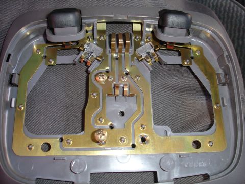 1992 Ford Explorer - Close-up of a vehicle's interior light assembly, showing its internal wiring and components.