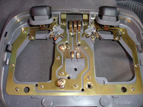 1992 Ford Explorer - Close-up of a vehicle's interior light fixture, showing its internal wiring and bulb sockets.