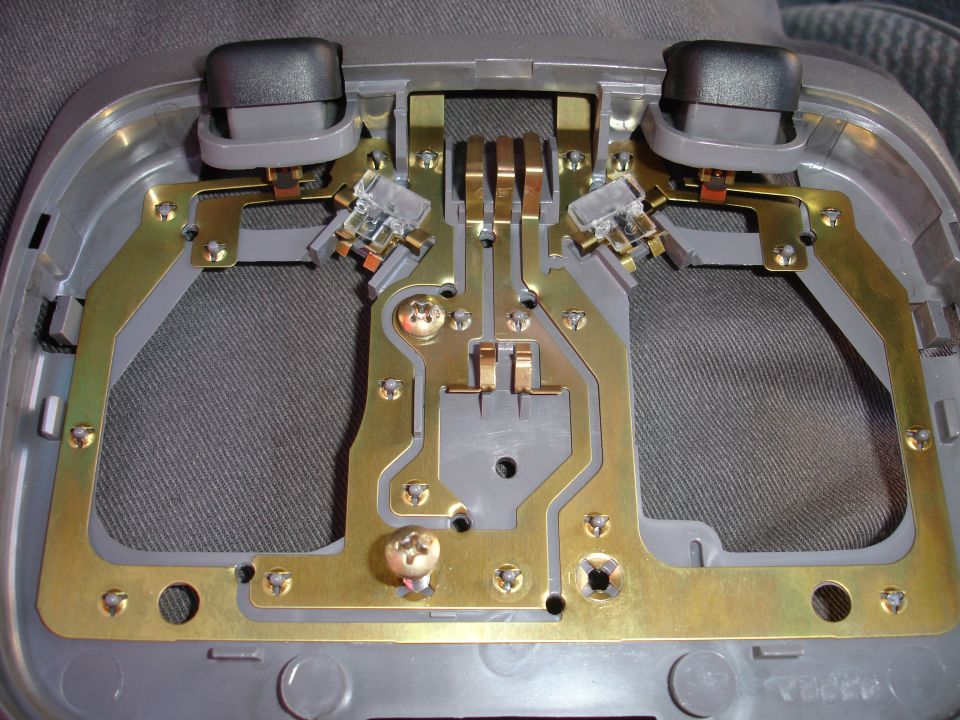 Interior light fixture with two black buttons and brass contacts