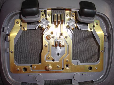 1992 Ford Explorer - Close-up of a vehicle's overhead dome light assembly, showing internal wiring and bulb sockets.