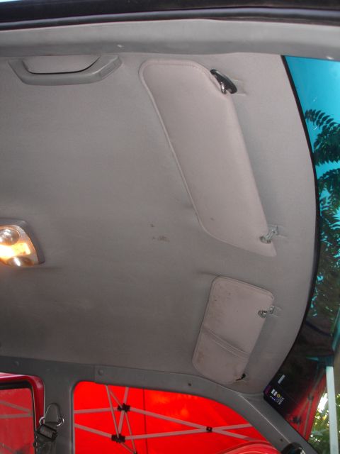 1992 Ford Explorer - The interior of a vehicle shows the headliner, sun visors, and interior light.