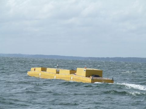 1978 Ford F-250 - A yellow modular floating structure moves through the water under a cloudy sky.
