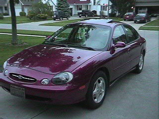 1999 Ford Taurus - Purple 1999 Ford Taurus parked in a suburban driveway.