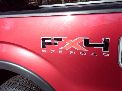 2009 Ford F-150 - The FX4 OFFROAD decal is visible on the side of the red truck.
