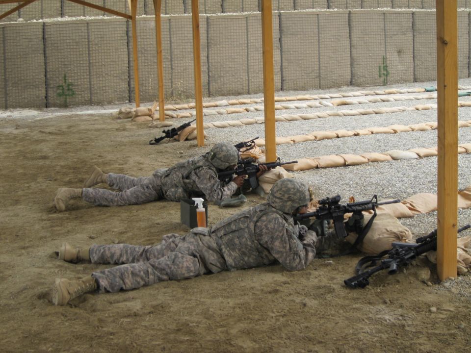 Soldiers prone at a firing range with rifles