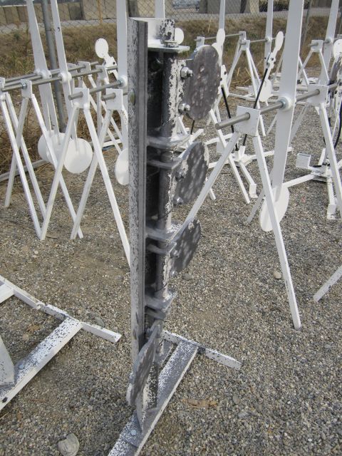 2003 Jeep Wrangler - A collection of reactive steel targets are set up on a gravelly outdoor range.