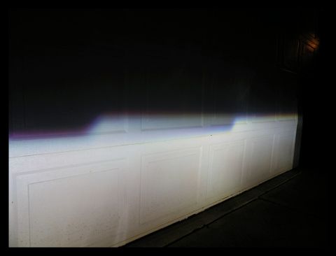1998 Subaru Legacy - Headlight beam pattern on a garage door at night.