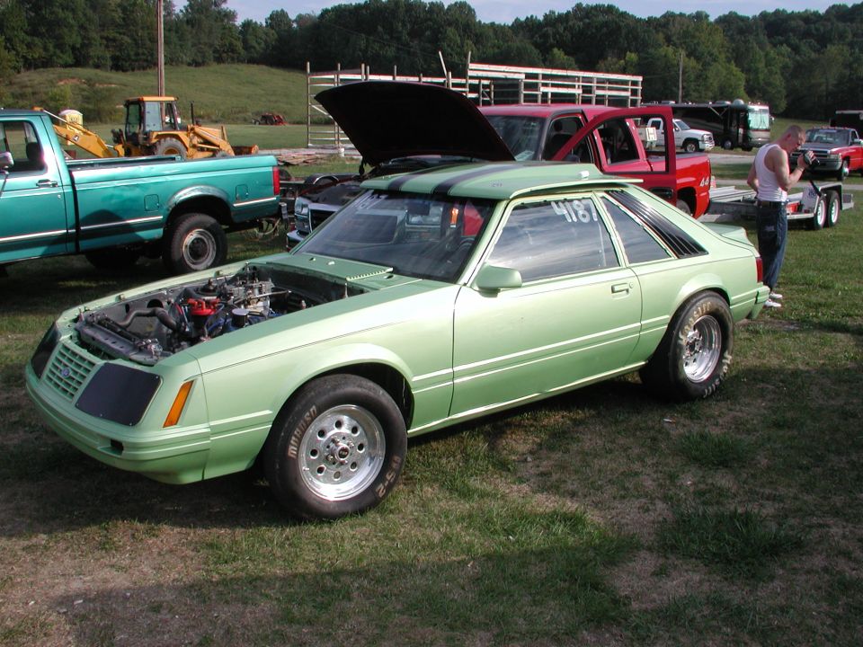 Light green coupe with racing stripes, hood open, drag tires, and number 4187 on the window
