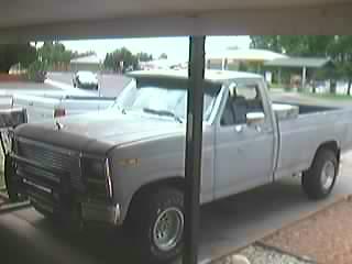 1985 Ford F-150 - Pickup truck with a prominent grille and front bumper, likely from the early 1980s.
