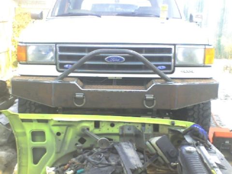 1989 Ford Bronco - Front view of a 1989 Ford Bronco with a custom bumper, showing disassembled parts below.