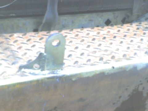 1989 Ford Bronco - Close-up of a metal bracket attached to a diamond plate surface, with Supermotors.net logo visible.