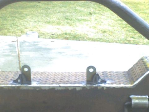 1989 Ford Bronco - Custom bumper brackets are shown welded onto a diamond plate surface.