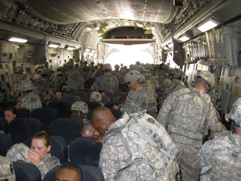 2003 Jeep Wrangler - Troops are packed into the interior of a large transport aircraft, likely preparing for deployment.