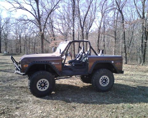 1967 Ford Mustang - This modified Ford Bronco is shown from the side, large off-road tires and a prominent roll cage.