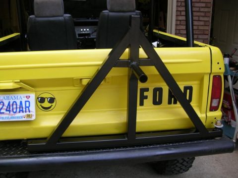 1967 Ford Mustang - Yellow Ford pickup truck rear with custom spare tire carrier and Alabama license plate.