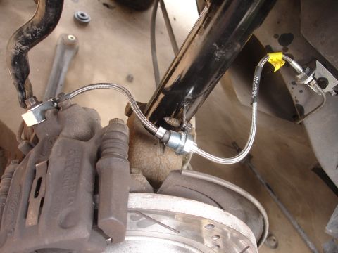 1995 Ford Taurus - Stainless steel brake lines are connected to the caliper and shock absorber assembly.