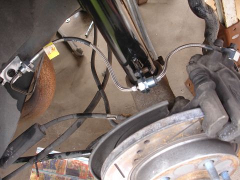 1995 Ford Taurus - Rear brake assembly with new stainless steel brake lines installed.