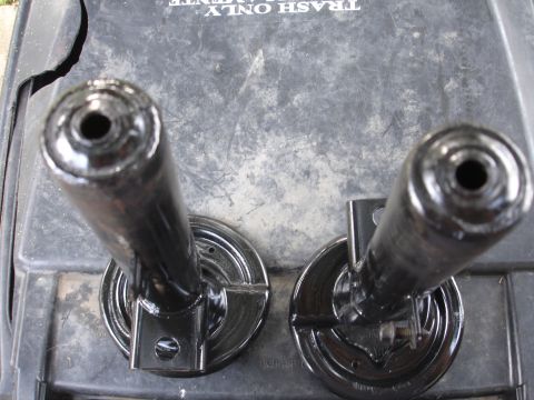 1995 Ford Taurus - Two black suspension components are shown resting on a gray surface with text indicating 'TRASH ONLY'.