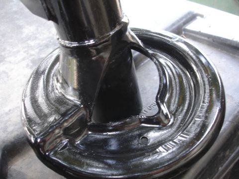 1995 Ford Taurus - A shiny black suspension component is shown in detail, with some text visible on its base.