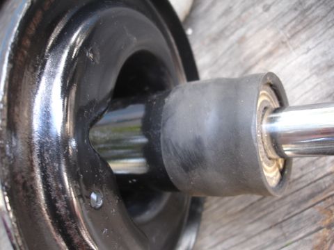 1995 Ford Taurus - A close-up view of a suspension component, likely a strut mount or similar part, a rubber boot and visible bearing.