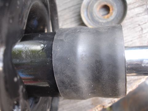 1995 Ford Taurus - A rubber boot covers a metal shaft, likely a component from a vehicle's suspension system.