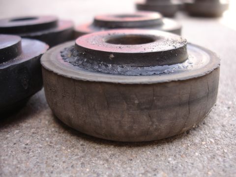1995 Ford Taurus - Close-up of multiple rubber suspension bushings, showing wear and cracking on the rubber components.