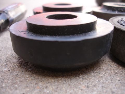1995 Ford Taurus - These rubber bushings are likely replacement parts for a vehicle's suspension system.