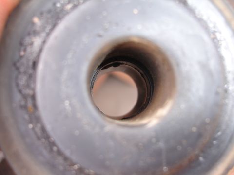 1995 Ford Taurus - A close-up view of a metal component, focusing on its central aperture.