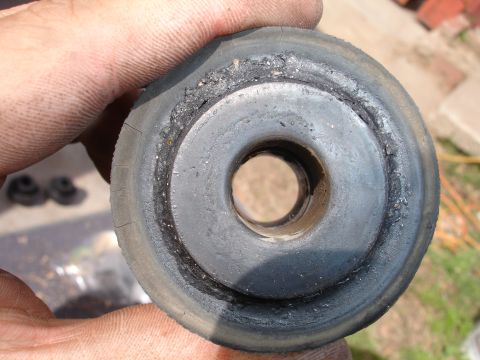 1995 Ford Taurus - This rubber bushing shows significant wear and damage, indicating it may need replacement.