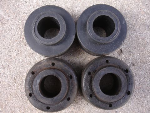 1995 Ford Taurus - Set of four rubber suspension bushings, two appear new, two show wear.