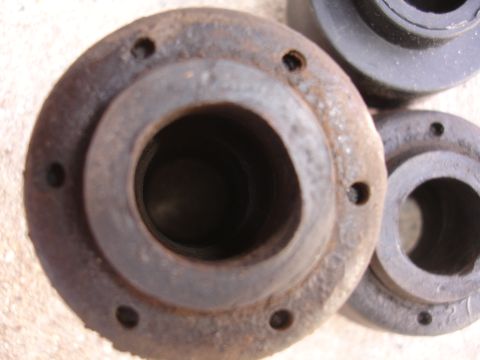 1995 Ford Taurus - A close-up view of a rusty metal component, likely a suspension part, with visible bolt holes.