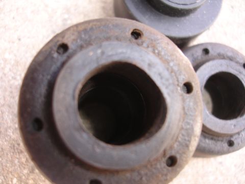 1995 Ford Taurus - Several metal bushings are shown in this close-up photo, with two in sharp focus.