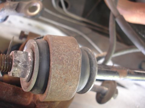 1995 Ford Taurus - Close-up view of a corroded suspension bushing assembly.