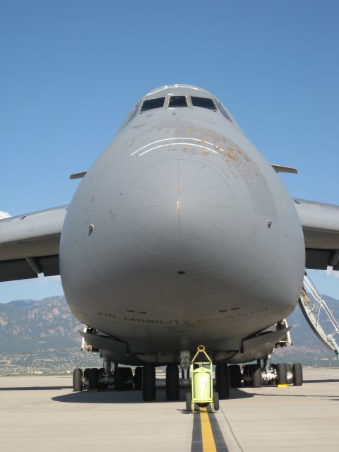 2003 Jeep Wrangler - Head-on view of a gray U.S. Air Force C-5 Galaxy cargo aircraft parked on a ramp, its bulbous nose lettered "AIR MOBILITY COMMAND" and show…