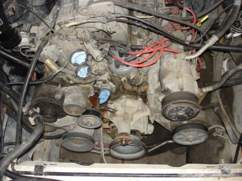 1992 Ford Bronco - Close-up view of an engine bay, highlighting the complex arrangement of belts and pulleys.