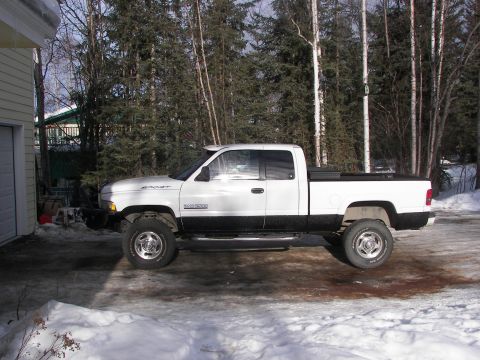 1990 Chevrolet Suburban - Side view of a white Dodge Ram pickup truck with a black two-tone paint scheme.
