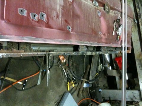 1993 Ford Bronco - Metal prep and tools for car door rust repair in a workshop setting.