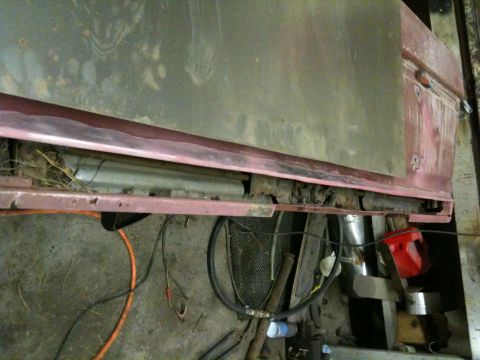 1993 Ford Bronco - Undercarriage and body panel detail of a vehicle showing significant rust and wear.