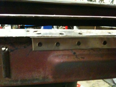 1993 Ford Bronco - Close-up view of a rusted metal frame, showing rivets and signs of wear.